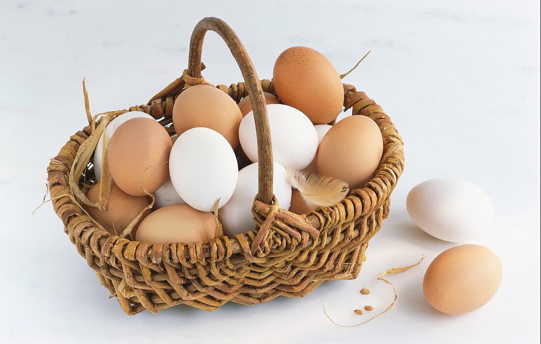 White and brown eggs in a basket
