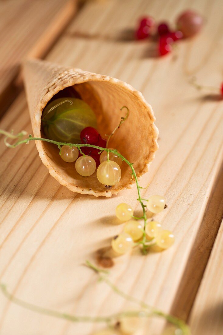 Redcurrants and whitecurrants, with gooseberries in a wafer cone
