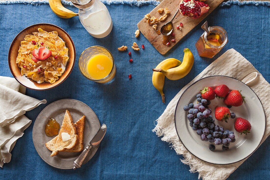 Assorted Breakfast Setting; Cold Cereal, Fruit, Toast and Orange Juice