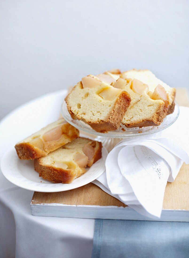 A few slices of upside-down pear cake on cake plates