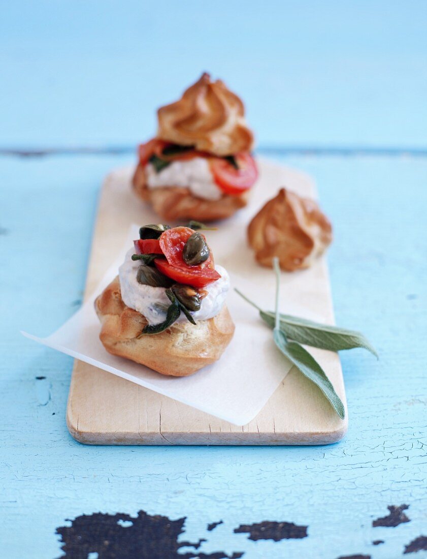 Profiteroles with tuna mousse, tomatoes, capers and sage