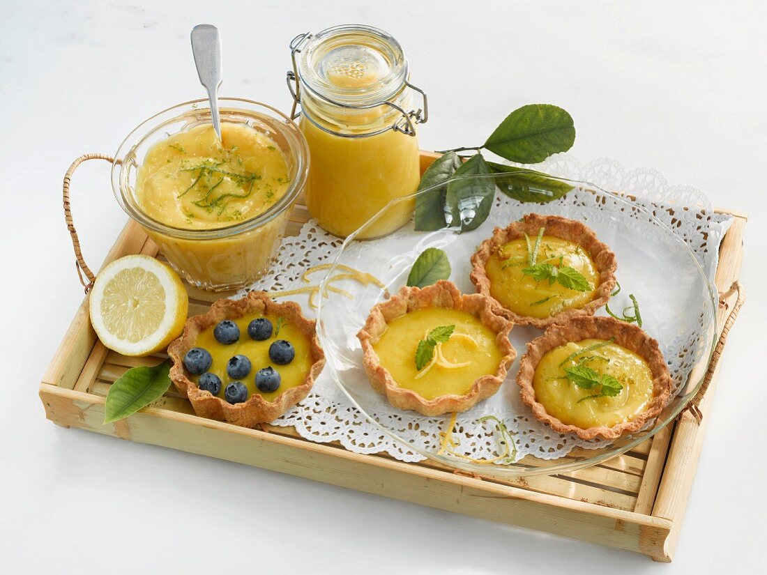 Lemon curd and lime curd in jars; tartlets with lemon curd and lime curd