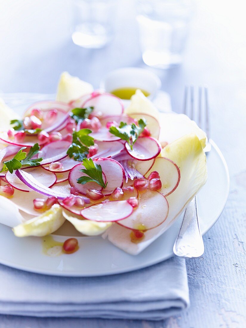 Chicory salad with radishes and pomegranate seeds