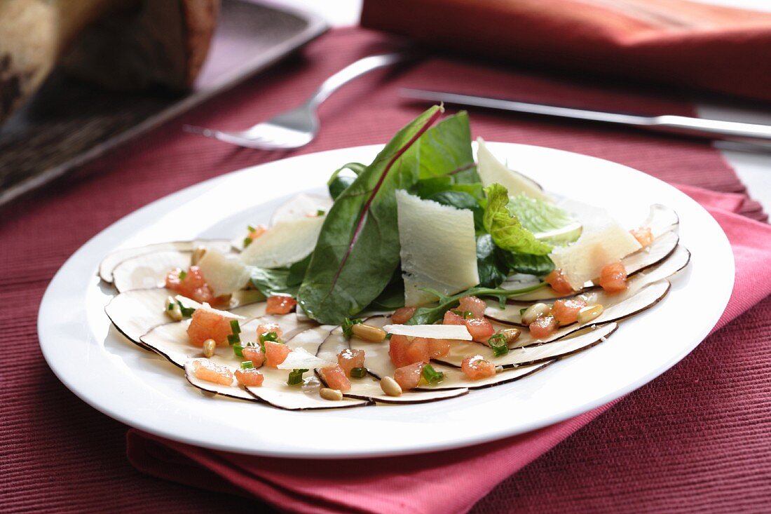 Mushroom carpaccio with pine nuts, vinaigrette and parmesan