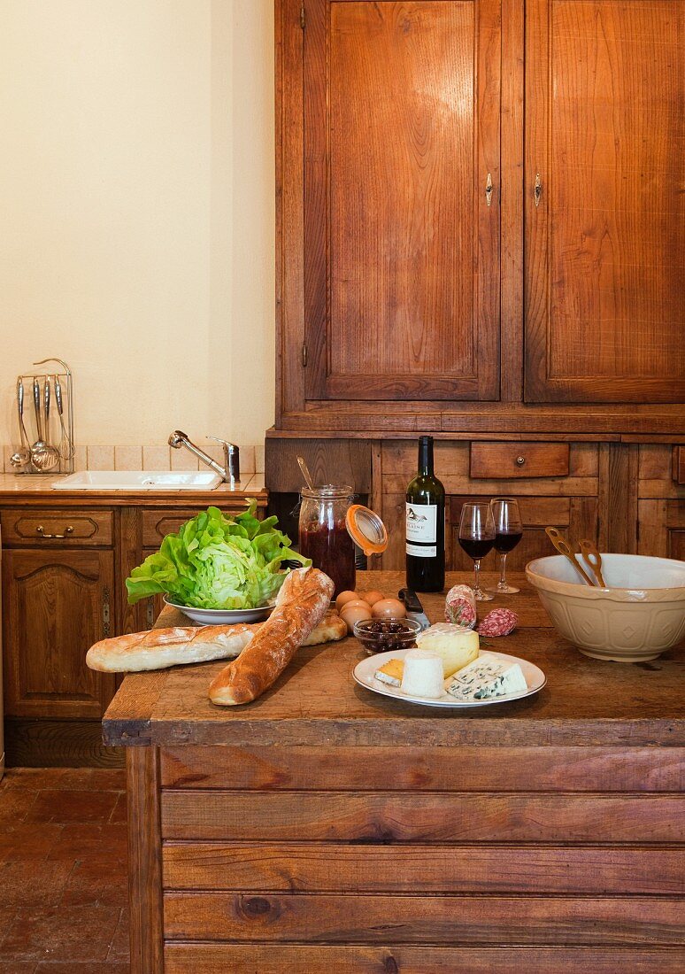 Food and wine on wooden table in kitchen