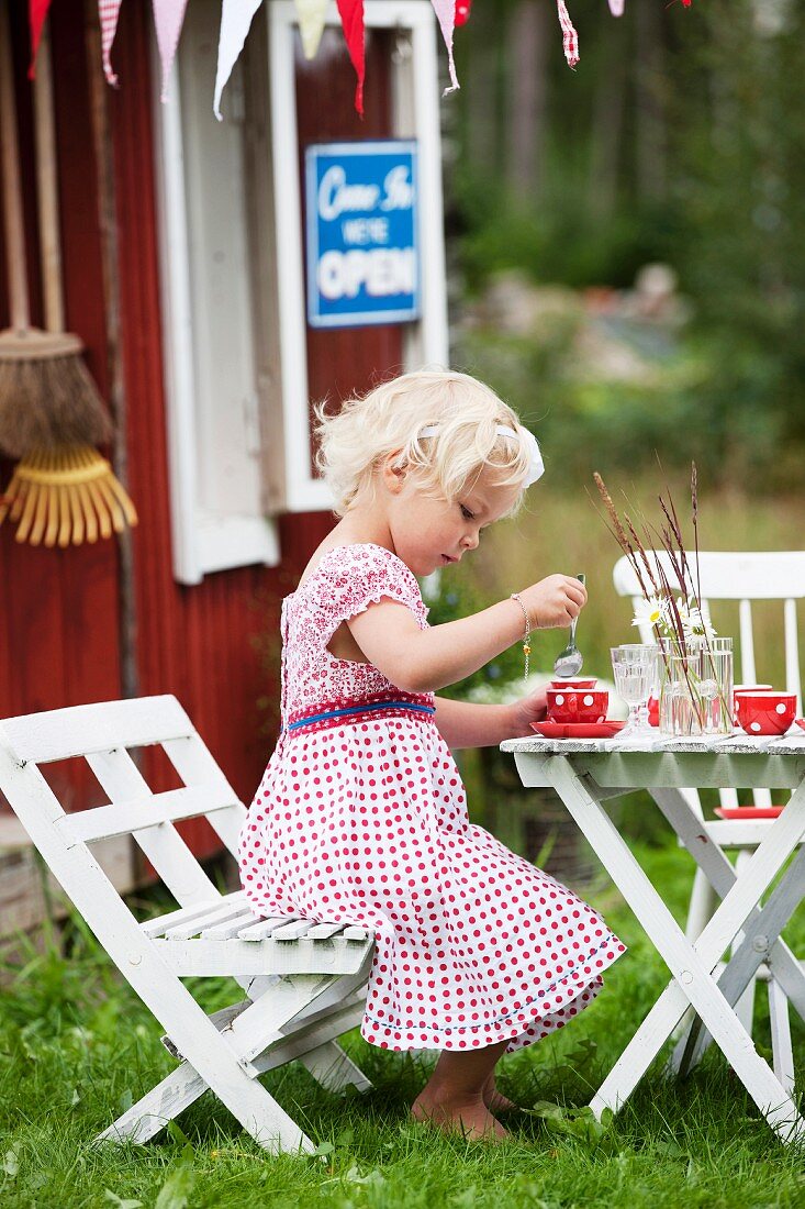 Girl playing in front of playhouse