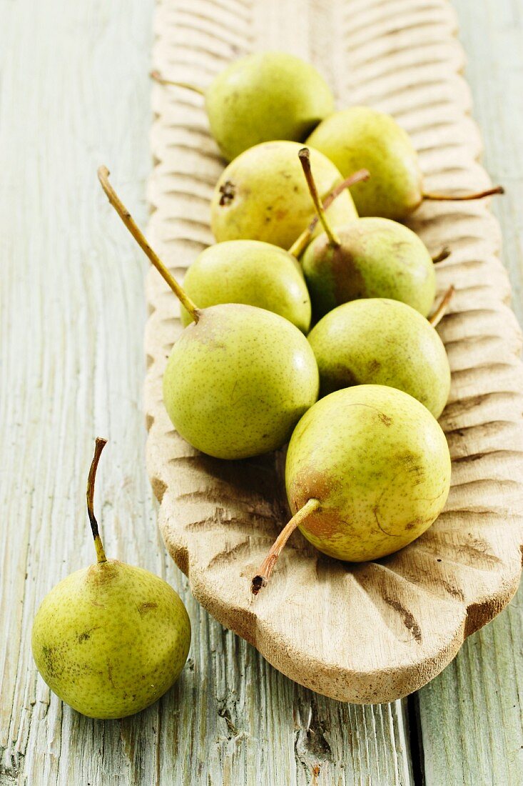 Several cooking pears in a wooden dish