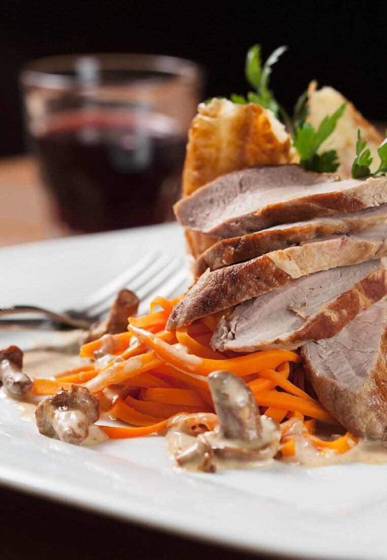 Roast pork with carrots and a mushroom sauce