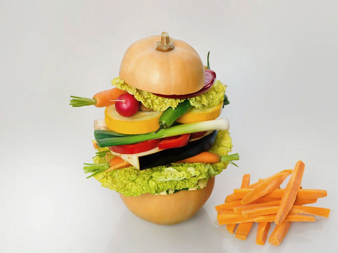 Healthy diet illustrated by a raw vegetarian burger and carrot chips