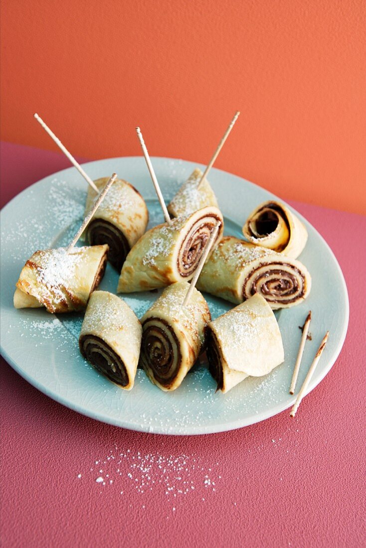 Rolled pancakes filled with hazelnut spread