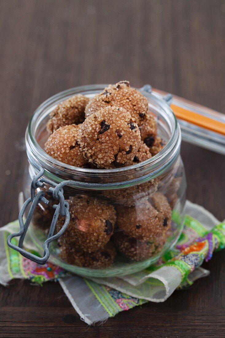 Apricot ginger bites with cocoa nibs in glass jar