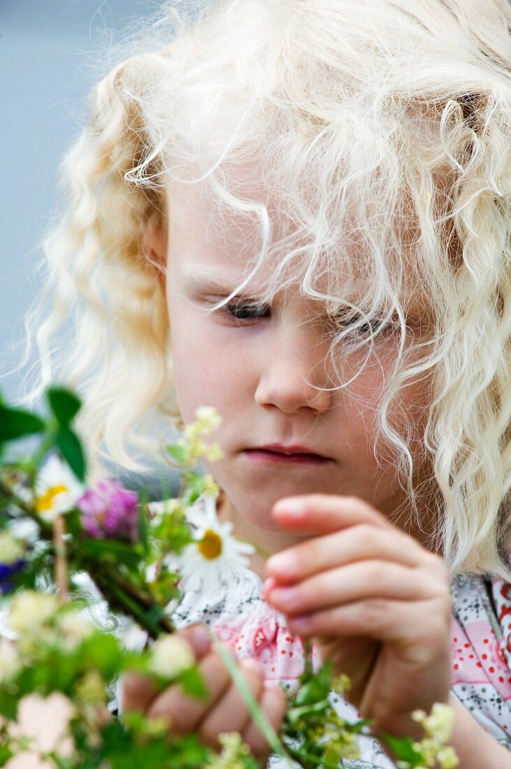 Blonde girl holding flowers