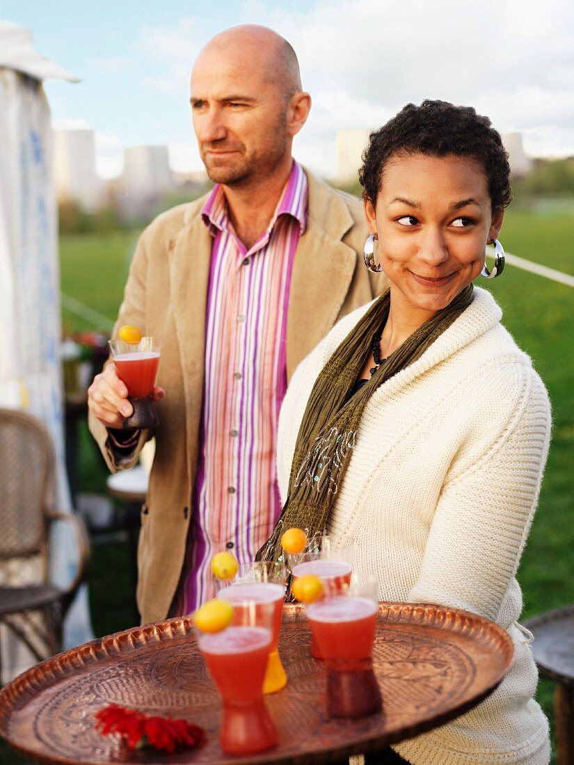 A woman with drinks on a tray, Sweden.