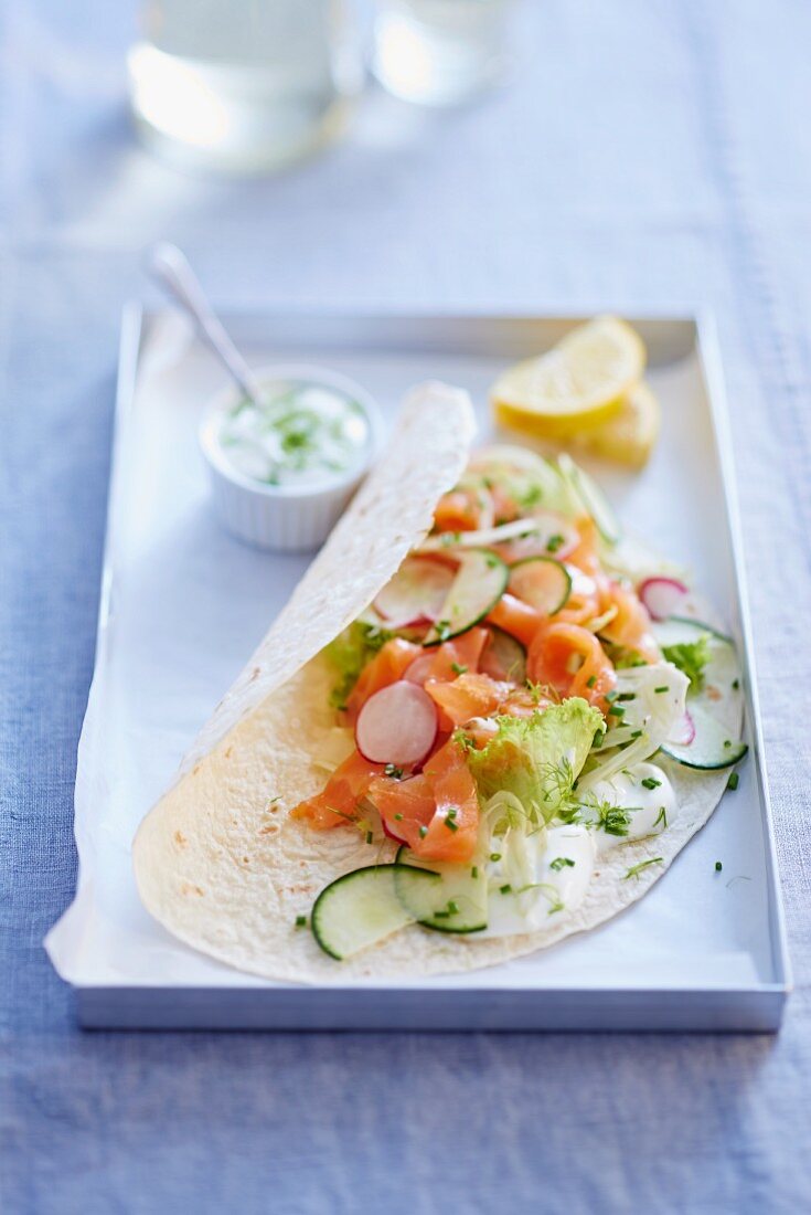 Wrap filled with smoked salmon, cucumber and radishes