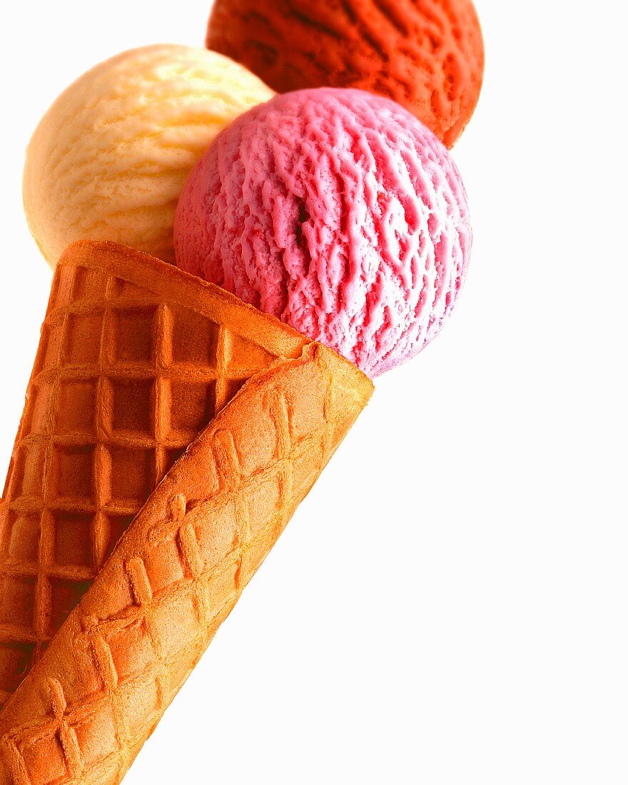 An ice cream cone with three scoops of ice cream (strawberry, vanilla, chocolate)
