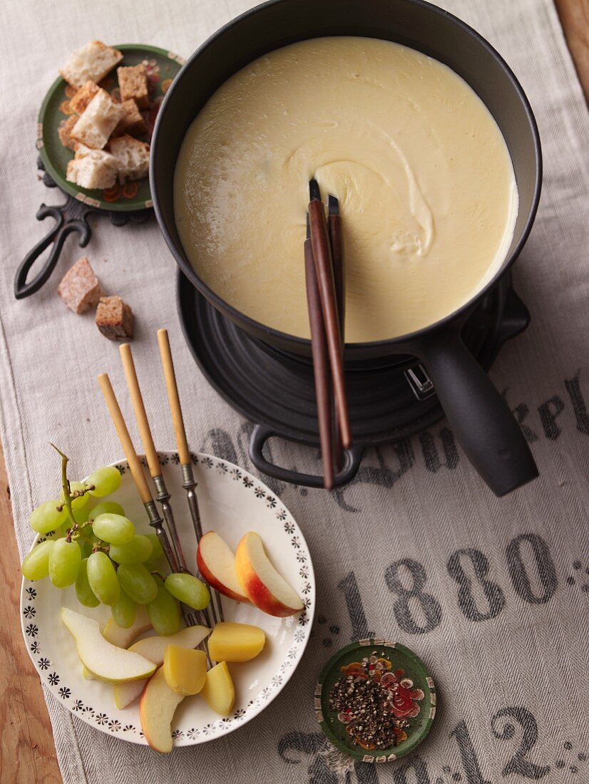 Cheese fondue with fruit and diced bread