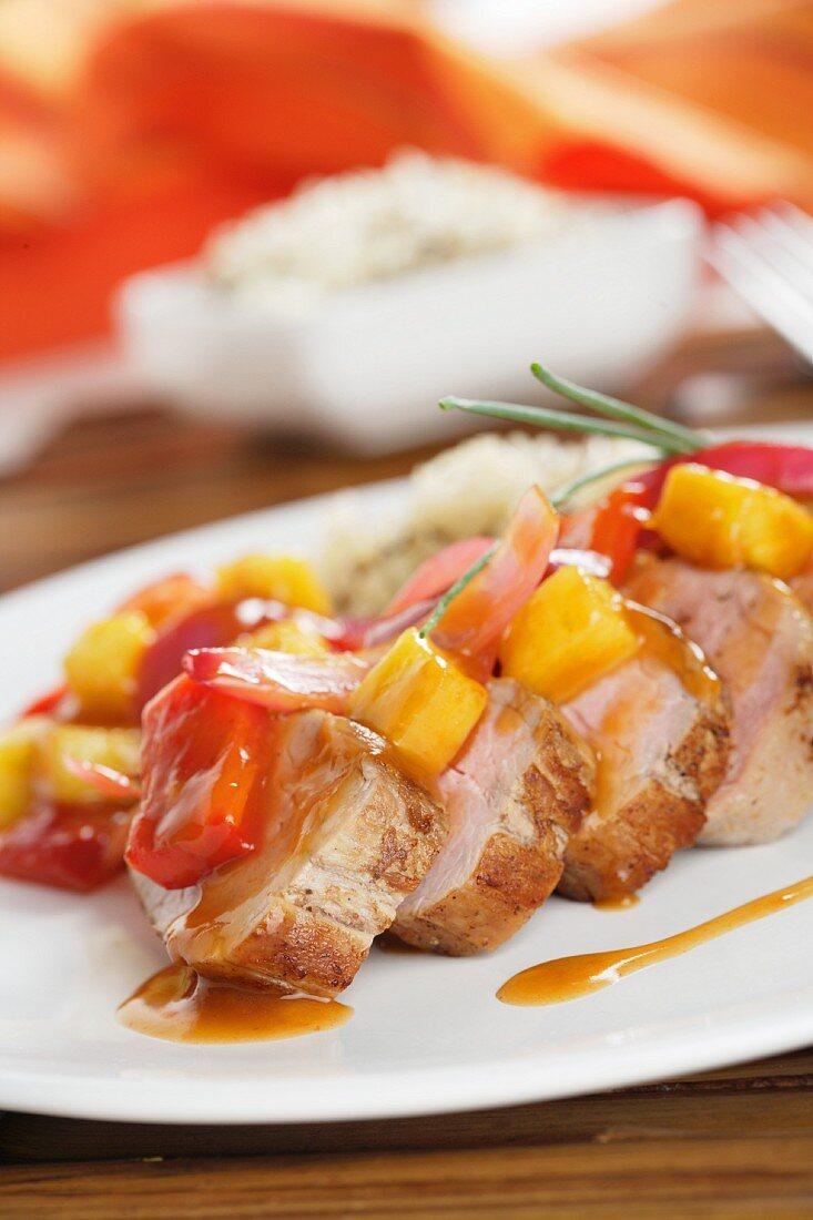 Detail sour pork tenderloin with peppers and rice