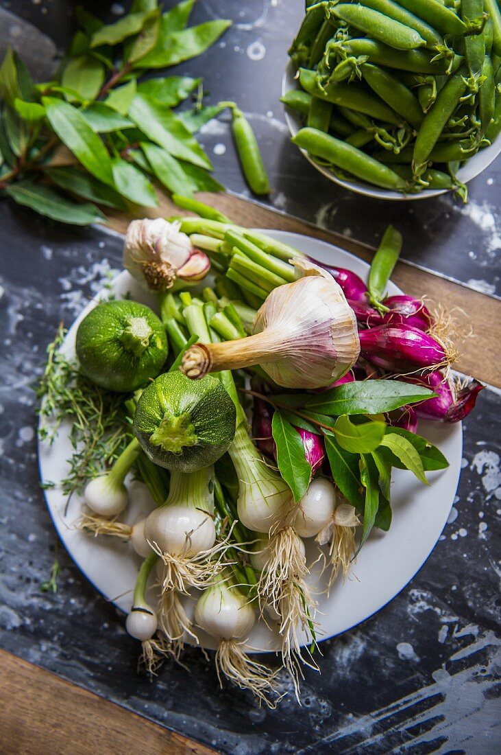 A plate of vegetables from the onion family and courgettes