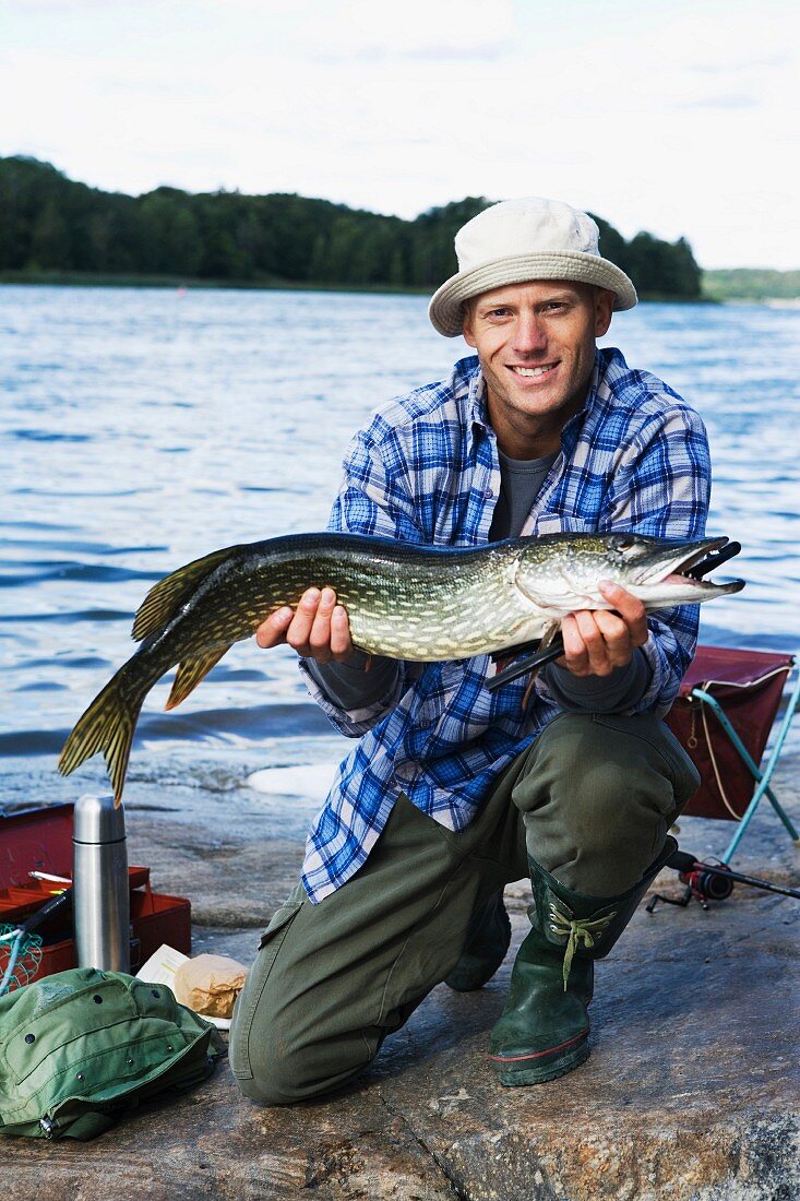 A man holding a pike, Sweden.