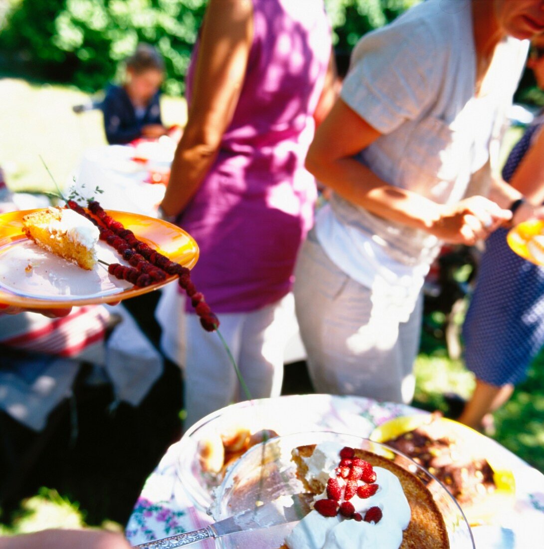 People eating cake at garden party