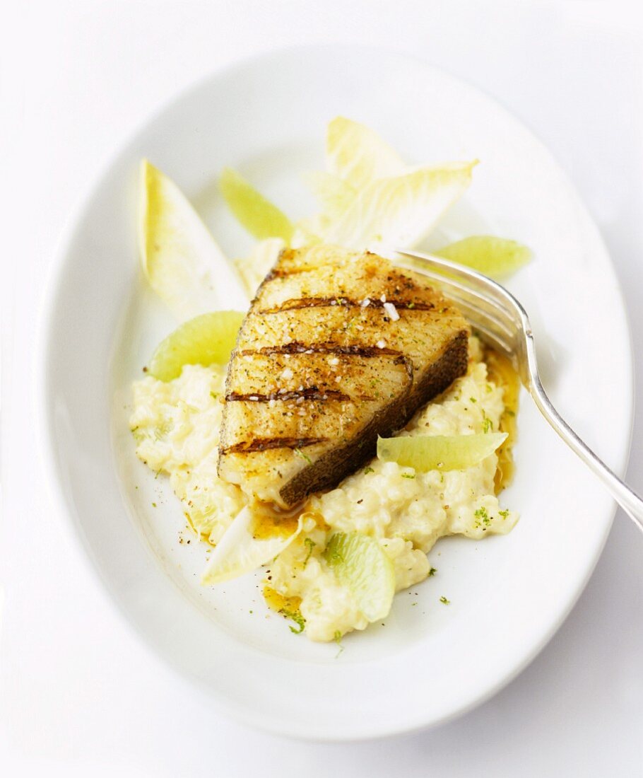 Grilled fish fillet on risotto with chicory