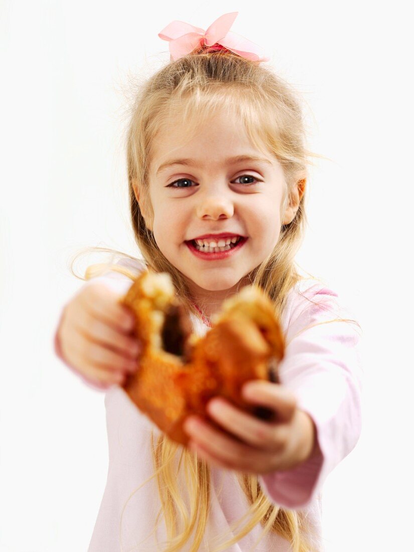 A small girl holding a hamburger