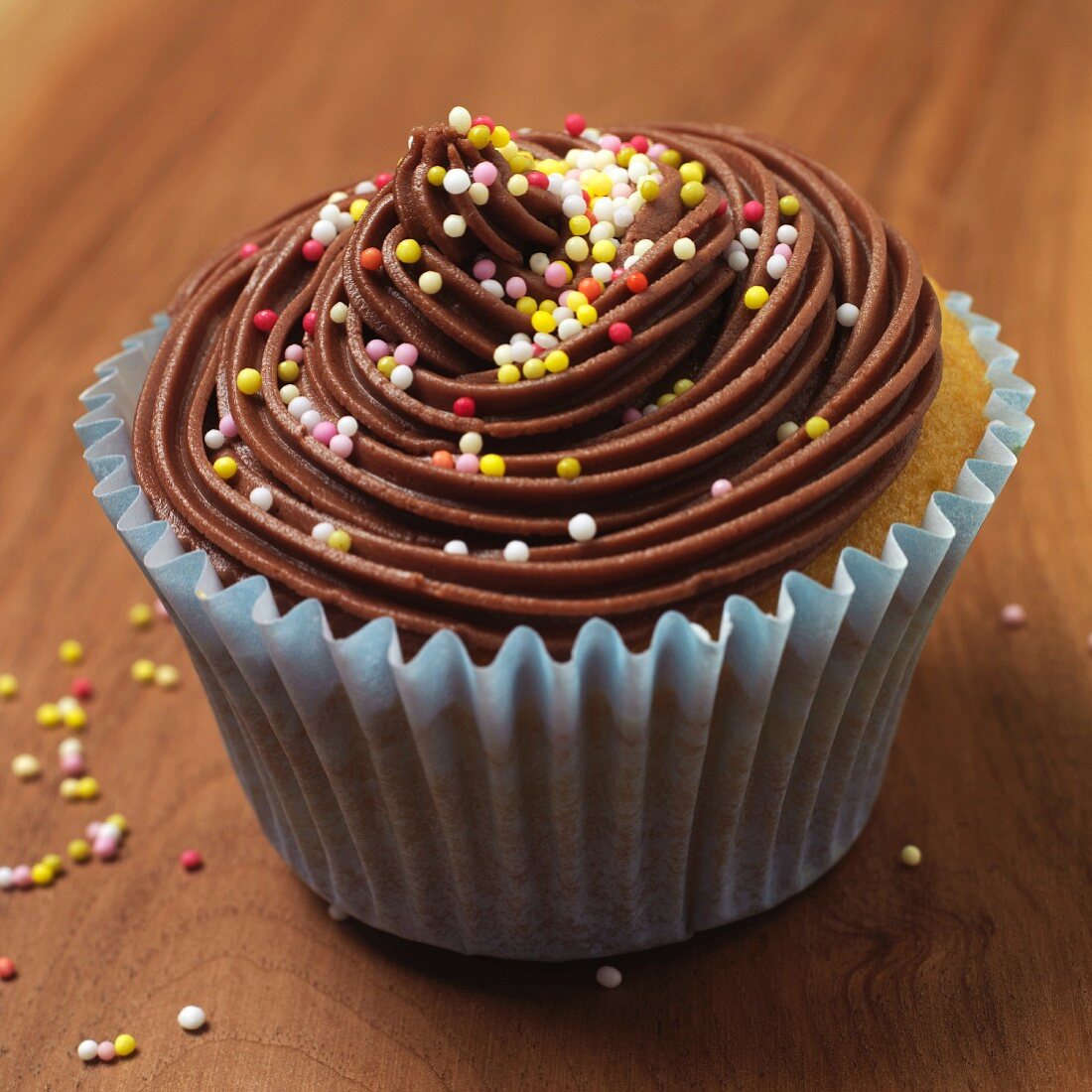 A chocolate cupcake with colourful sugar balls