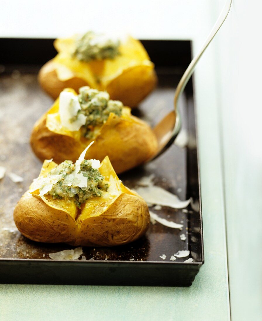Baked potatoes with pesto and parmesan