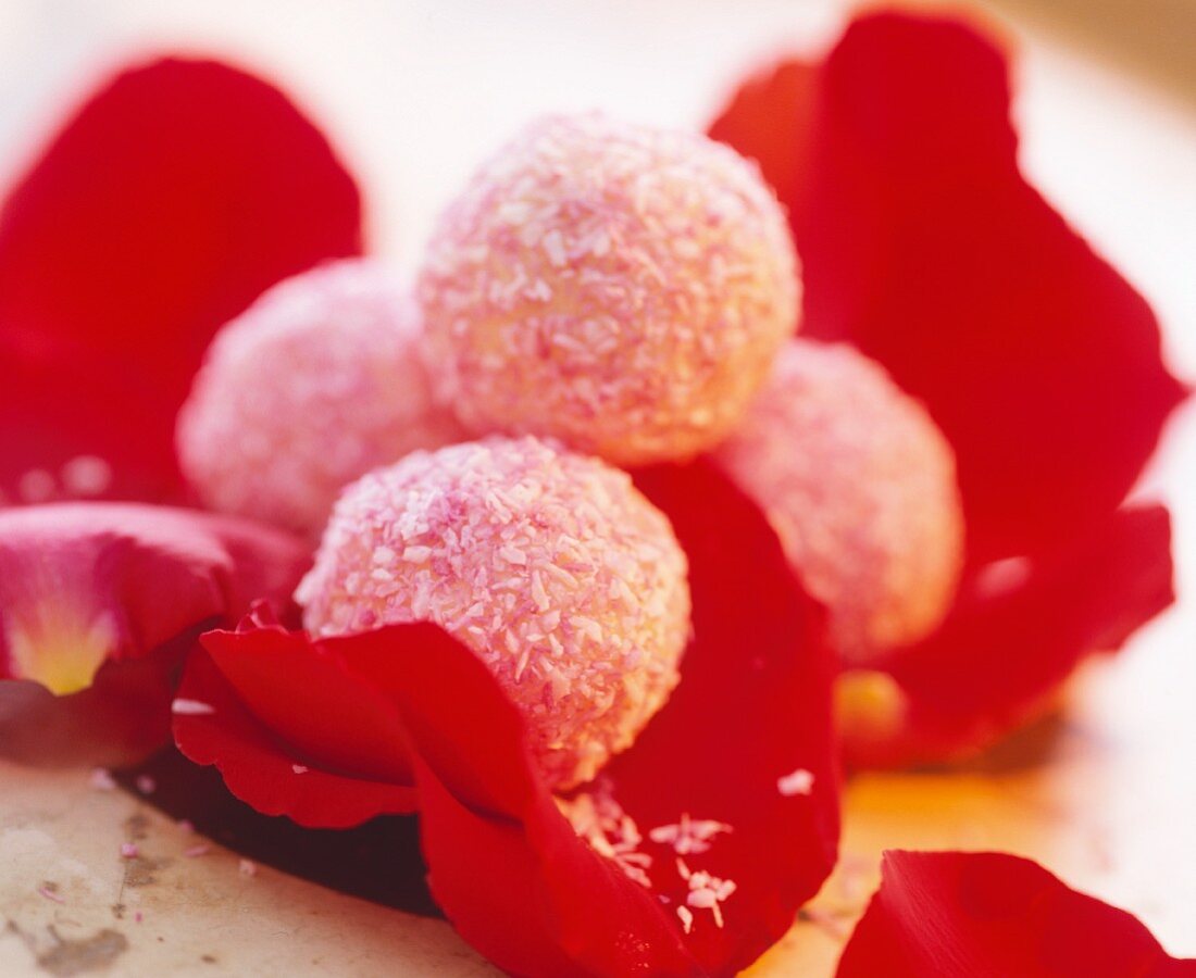 Coconut truffles on red rose petals