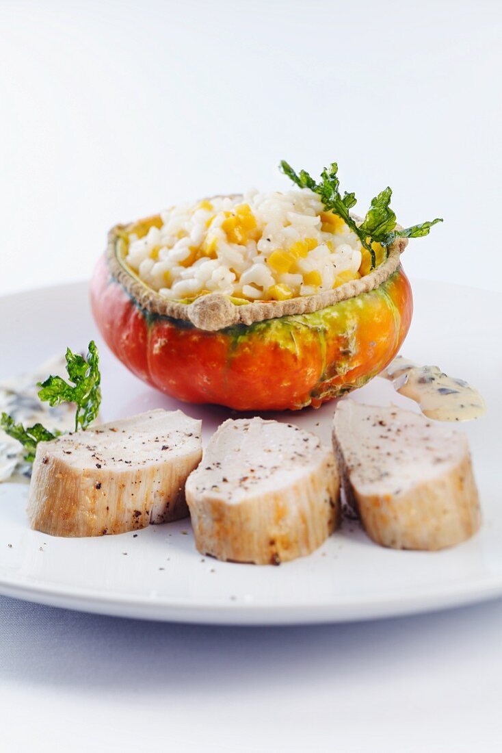 Squash risotto, served in a hollowed-out squash, with fried pork fillet