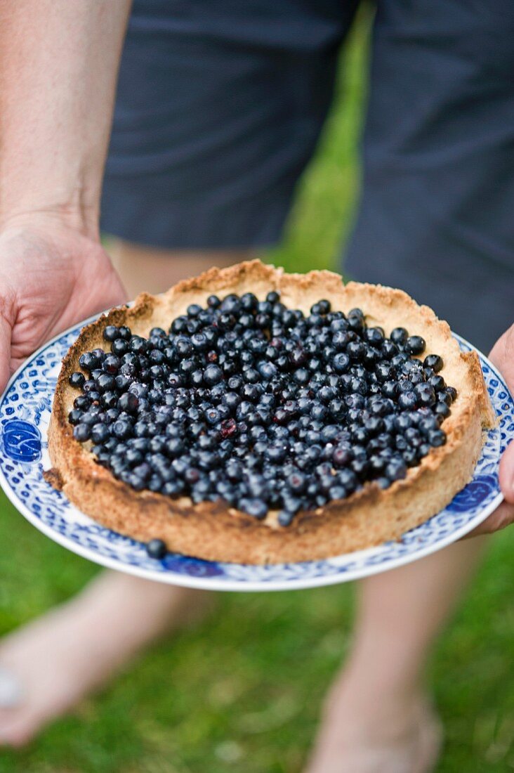 Man holding blueberry pie