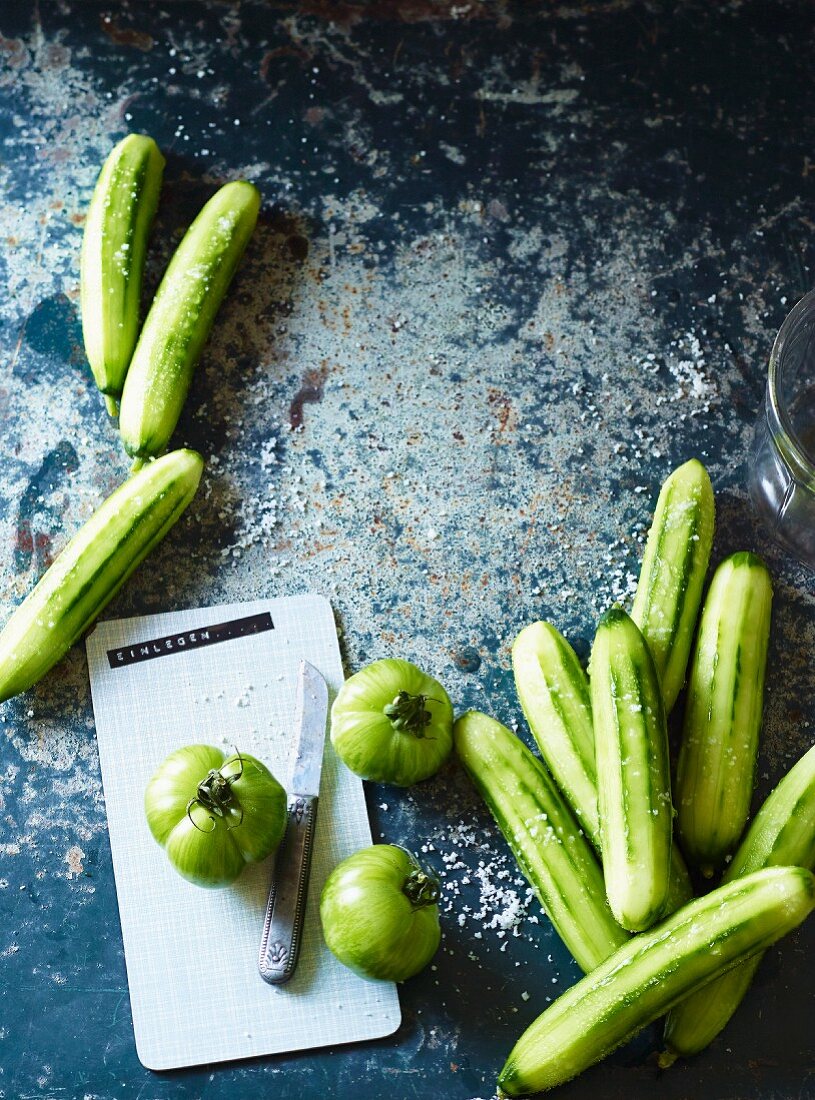 Green tomatoes and peeled cucumbers for pickling
