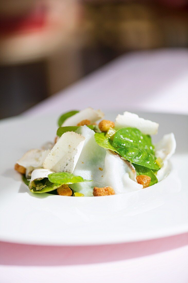 Spinach salad with rhubarb dressing, croutons and lardo