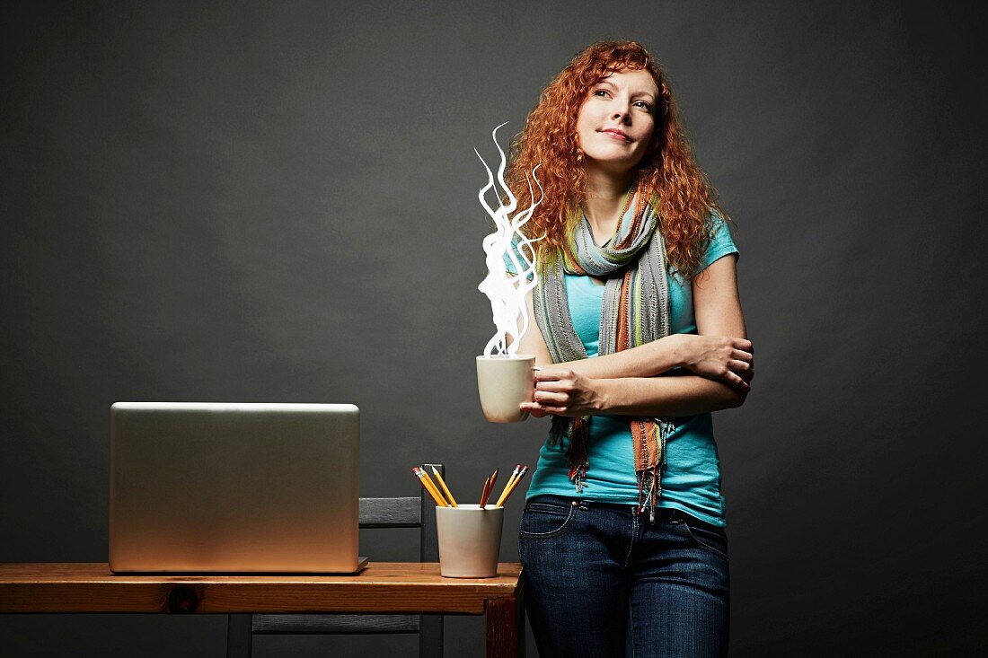 Woman enjoying cup of steaming hot beverage