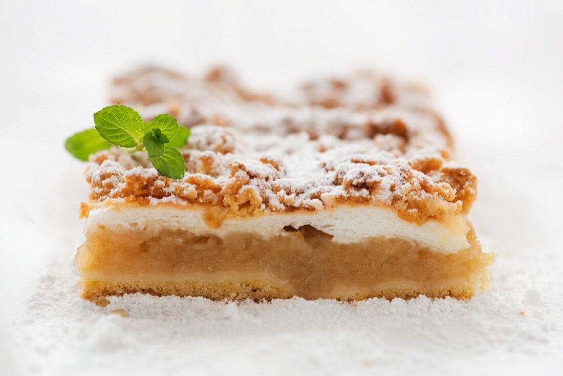 A slice of apple pie with crumble topping