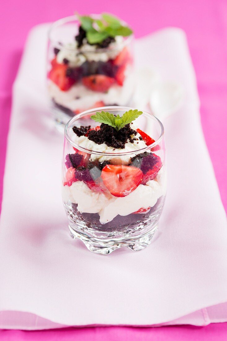 A layered dessert with strawberries and chocolate sponge