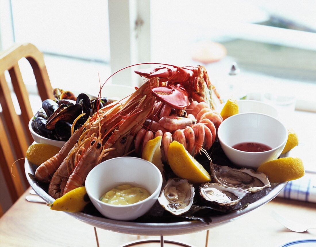 A platter of seafood with dips