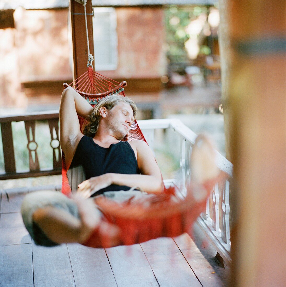 Young man sleeping iin a hammock