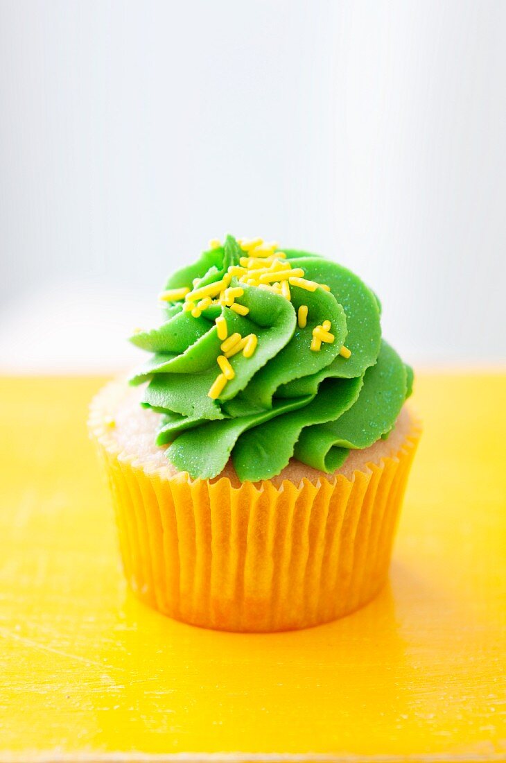 Orange cupcake with lime icing