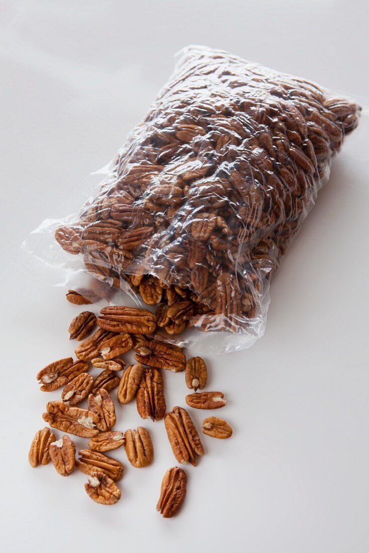 Pecan nuts spilling out of a plastic bag