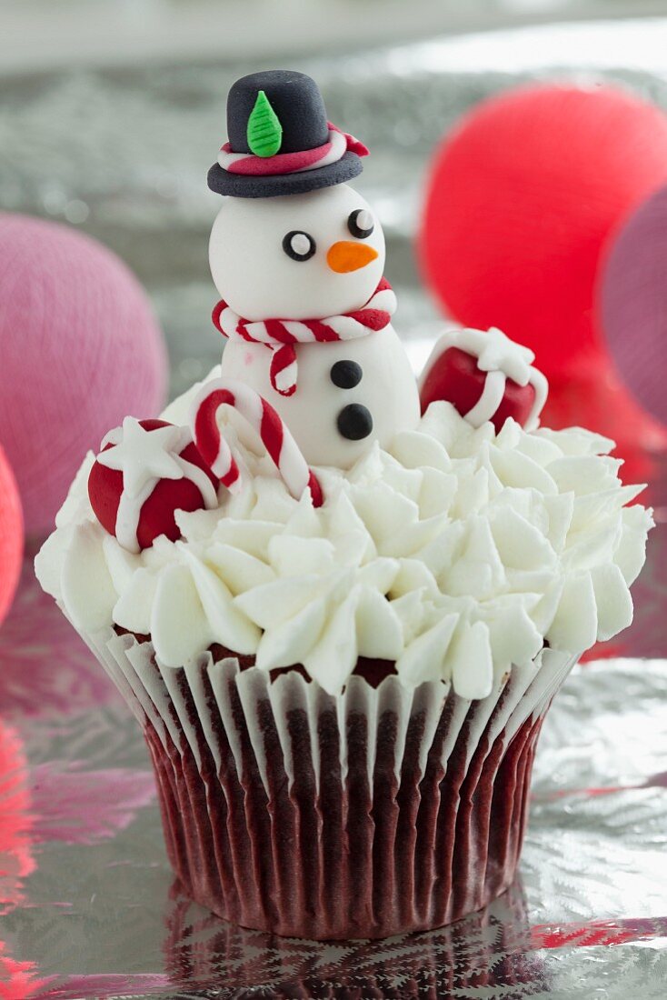 Red Velvet cupcake with cream cheese frosting and a snowman