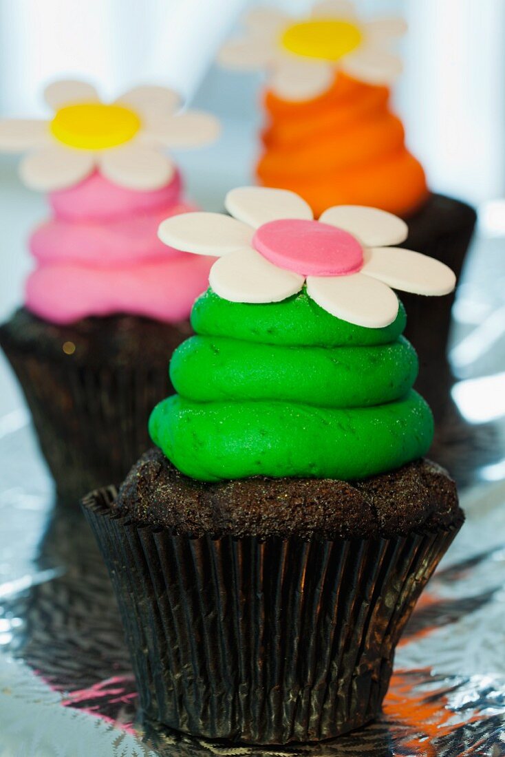 Chocolate cupcakes with colourful buttercream and sugar flowers