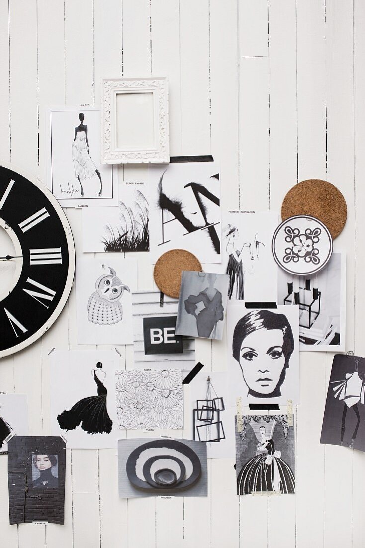 Black and white pictures, fashion sketches and vintage clock on white wood cladding