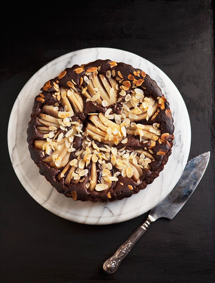 Chocolate cake with pears and flaked almonds (view from above)