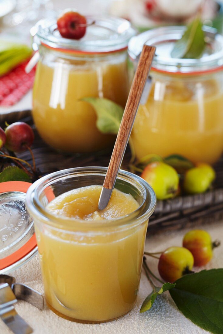 Apple sauce in small jars decorated with ornamental apples