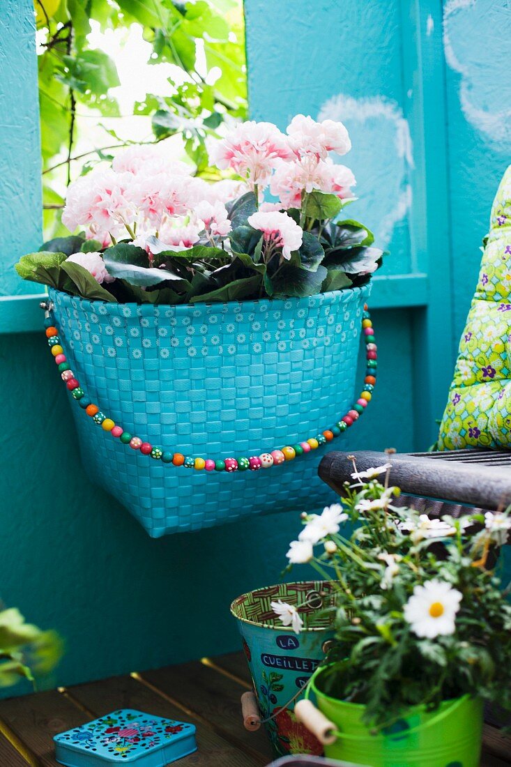 Basket of flowers on blue-painted wall