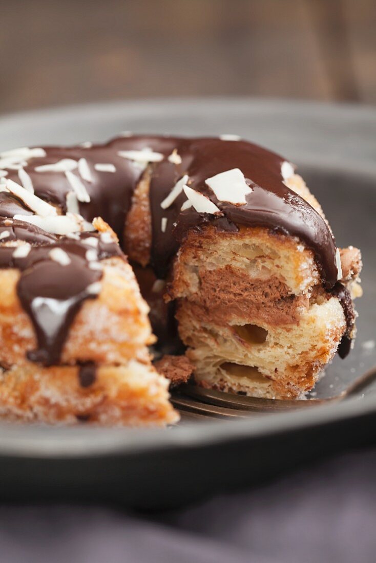 A crossover between a doughnut and a croissant, with chocolate glaze