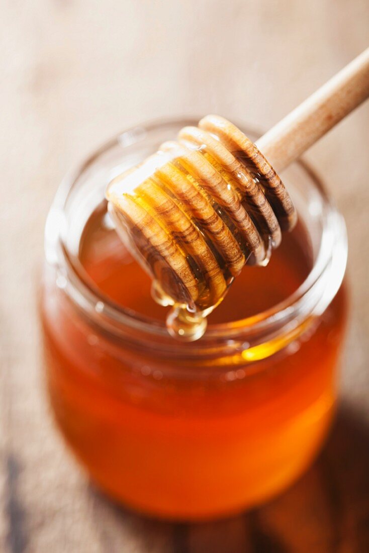 Jar of honey with honey dipper