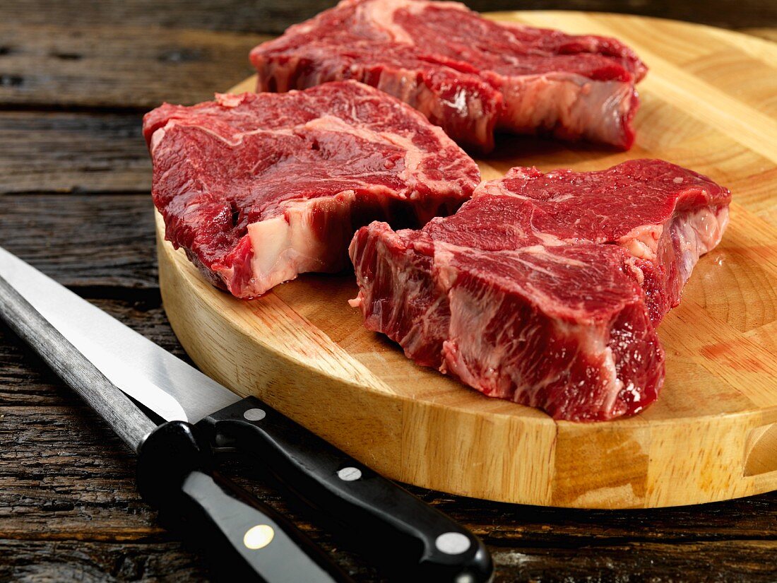 Rib eye steak on chopping board