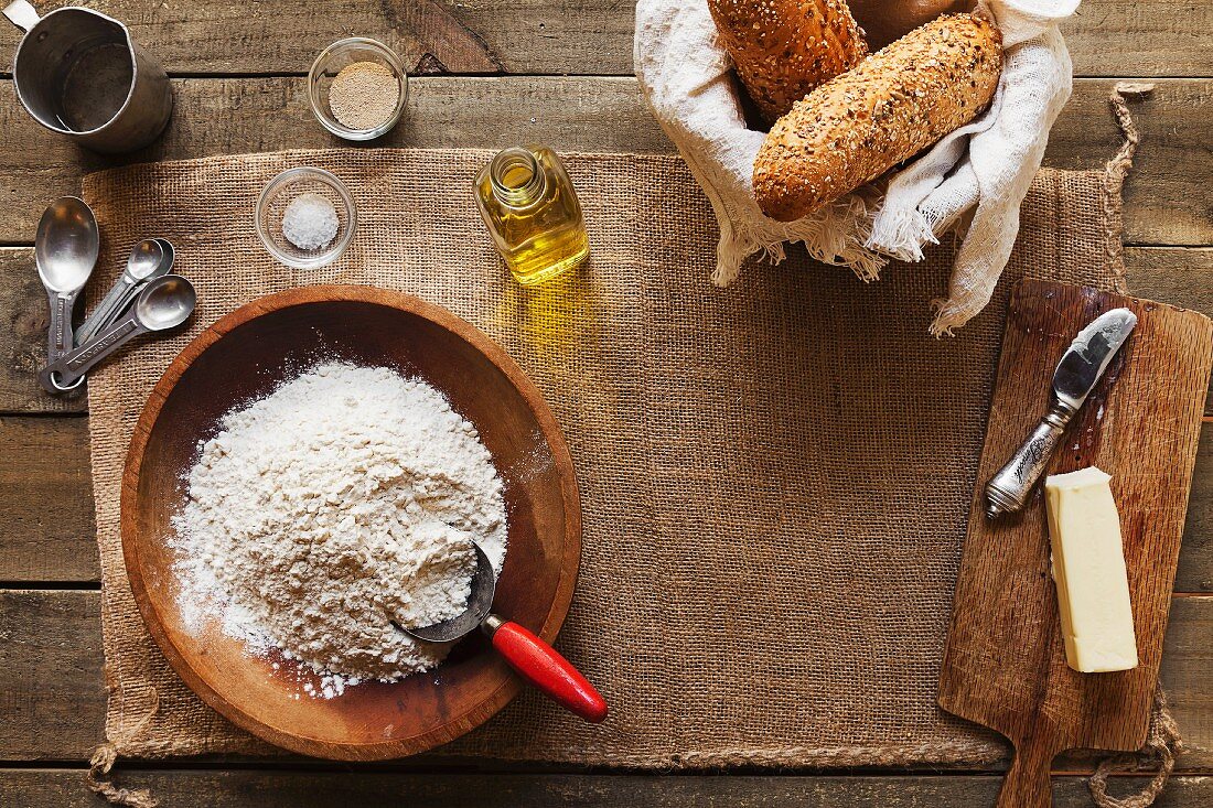 Overhead view of ingredients for making bread - flour, yeast, oil, butter, salt and water